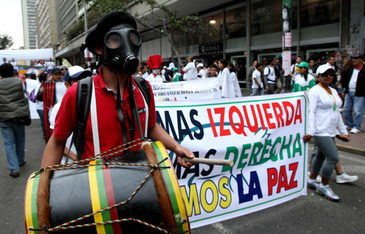 Un hombre con una máscara de gas participa en la Marcha por la Paz en Bogotá, Colombia, donde miles de colombianos expresaron su apoyo al proceso de paz del Gobierno con las FARC y al fin del conflicto armado.